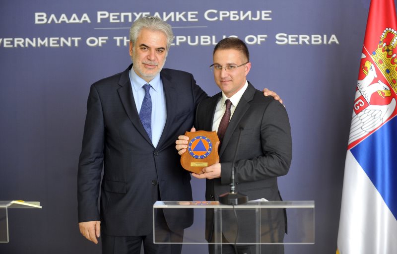 European Commissioner for Humanitarian Aid and Crisis Management Christos Stylianides gave him a plaque of EU Civil Protection  to  Serbia`s Internal Affairs Minister Nebojsa Stefanovic (right) signing of  Agreement on the participation of Serbia in the Union Civil Protection Mechanism   in Palace of Serbia , Belgrade on April, 16. 2015. AFP PHOTO / OLIVER BUNIC